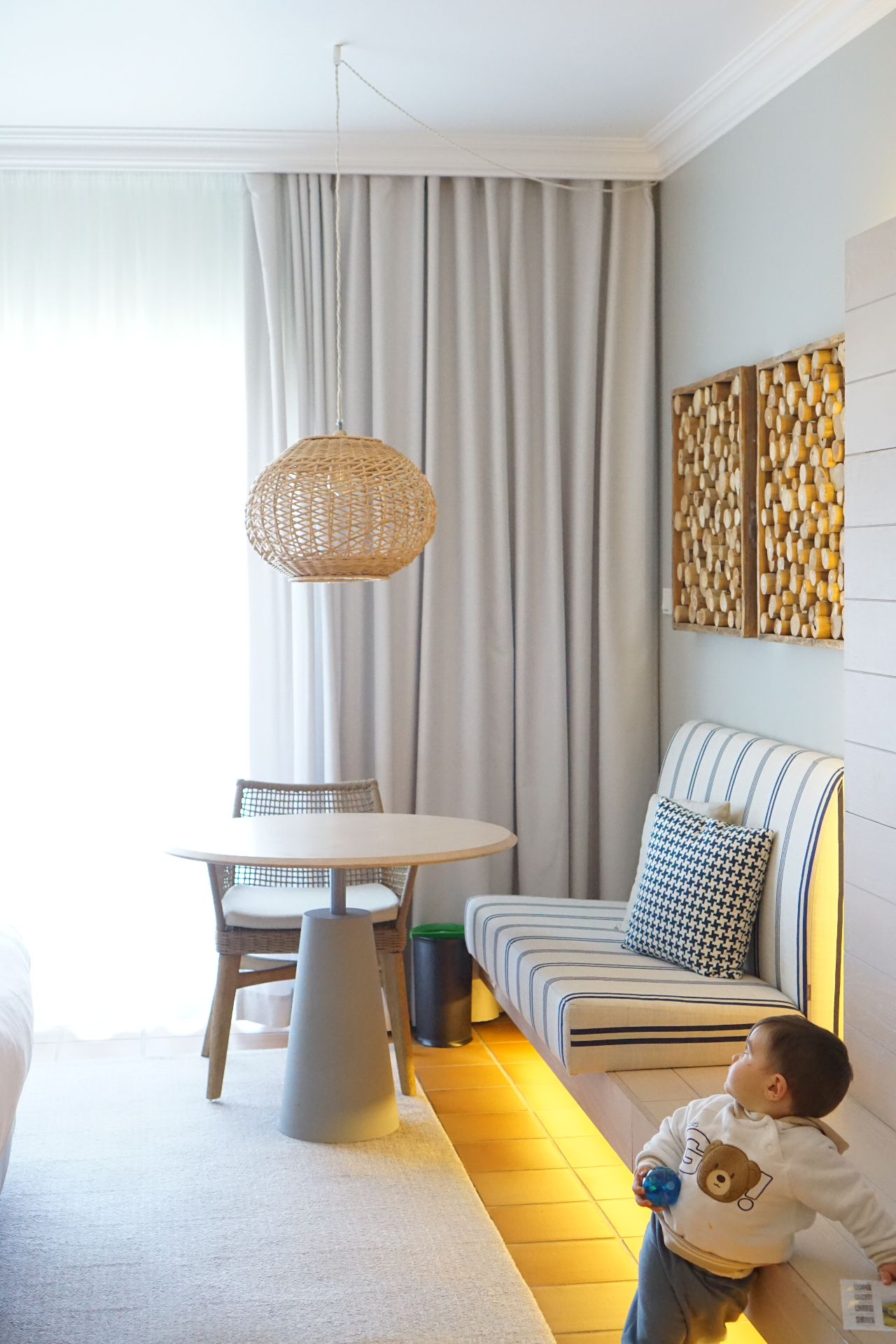 Toddler playing in a bright family hotel suite