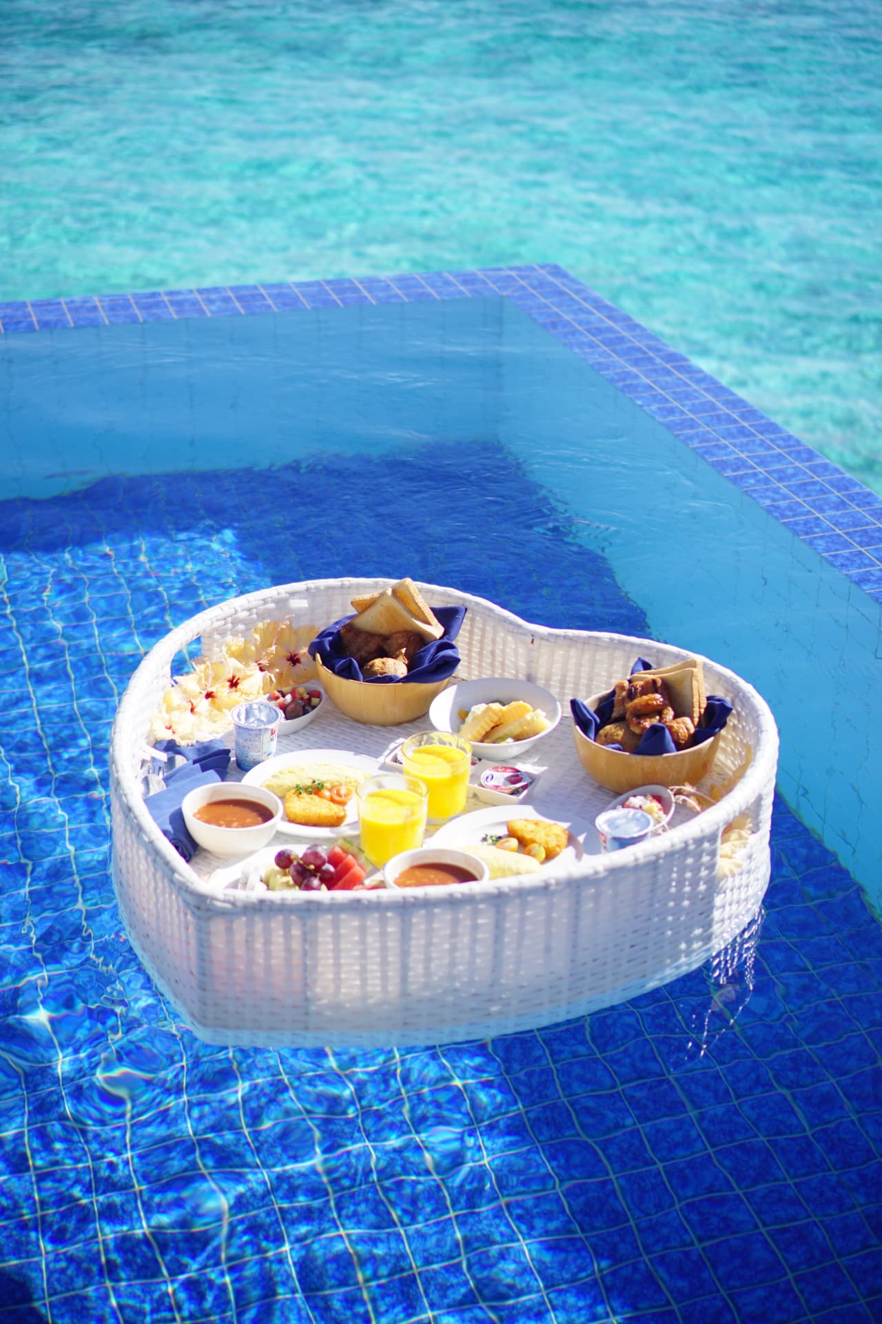 Floating breakfast tray in a turquoise private pool